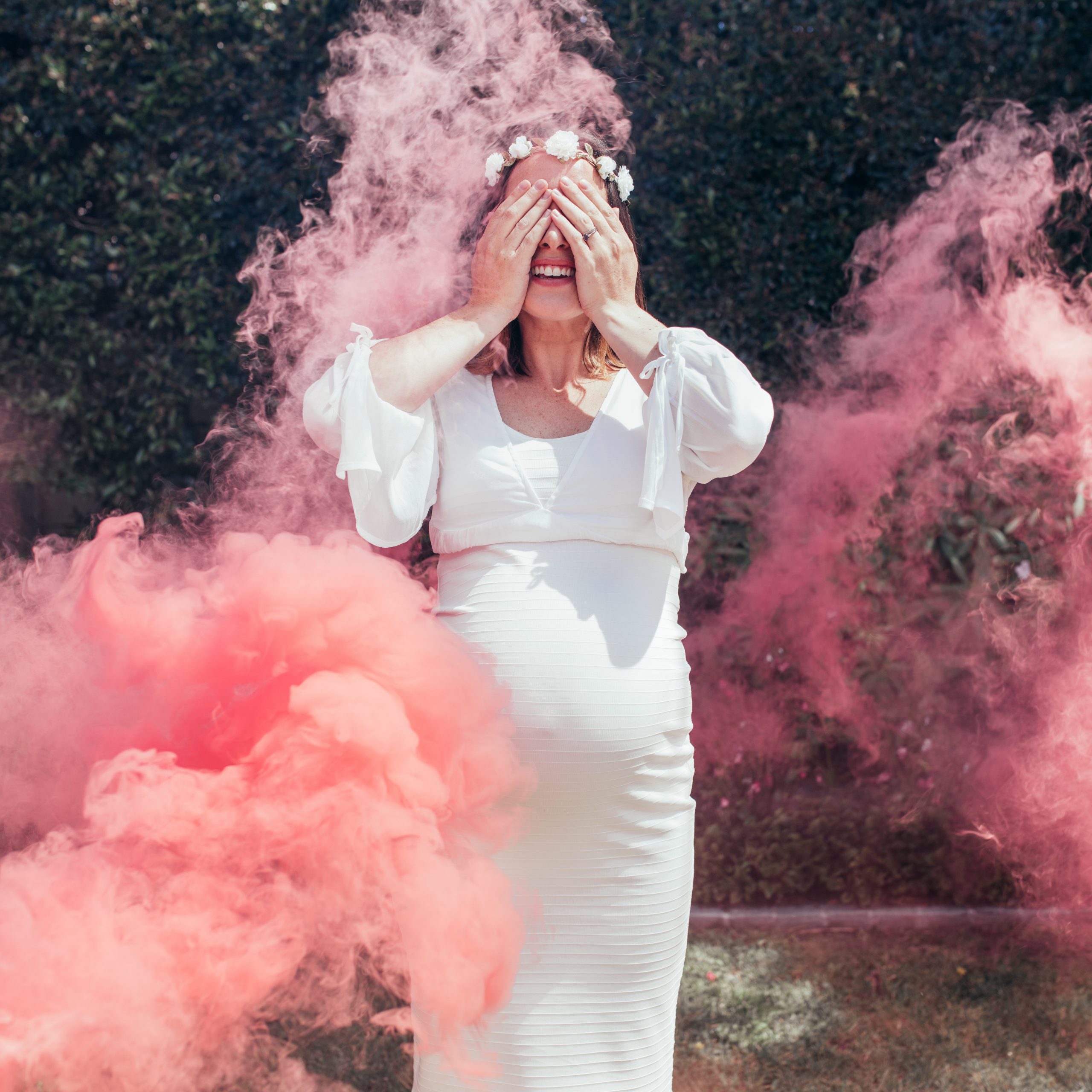 Happy,Pregnant,Woman,Covering,Her,Face,With,Smoke,Grenade,Outdoors.